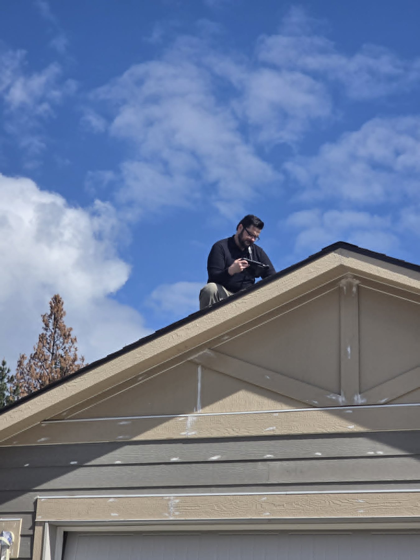 Bryan documenting roof conditions during a North Idaho property inspection