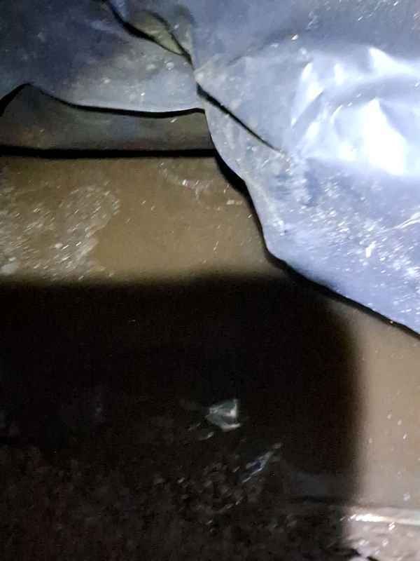 Standing water beneath a North Idaho home during a crawlspace inspection